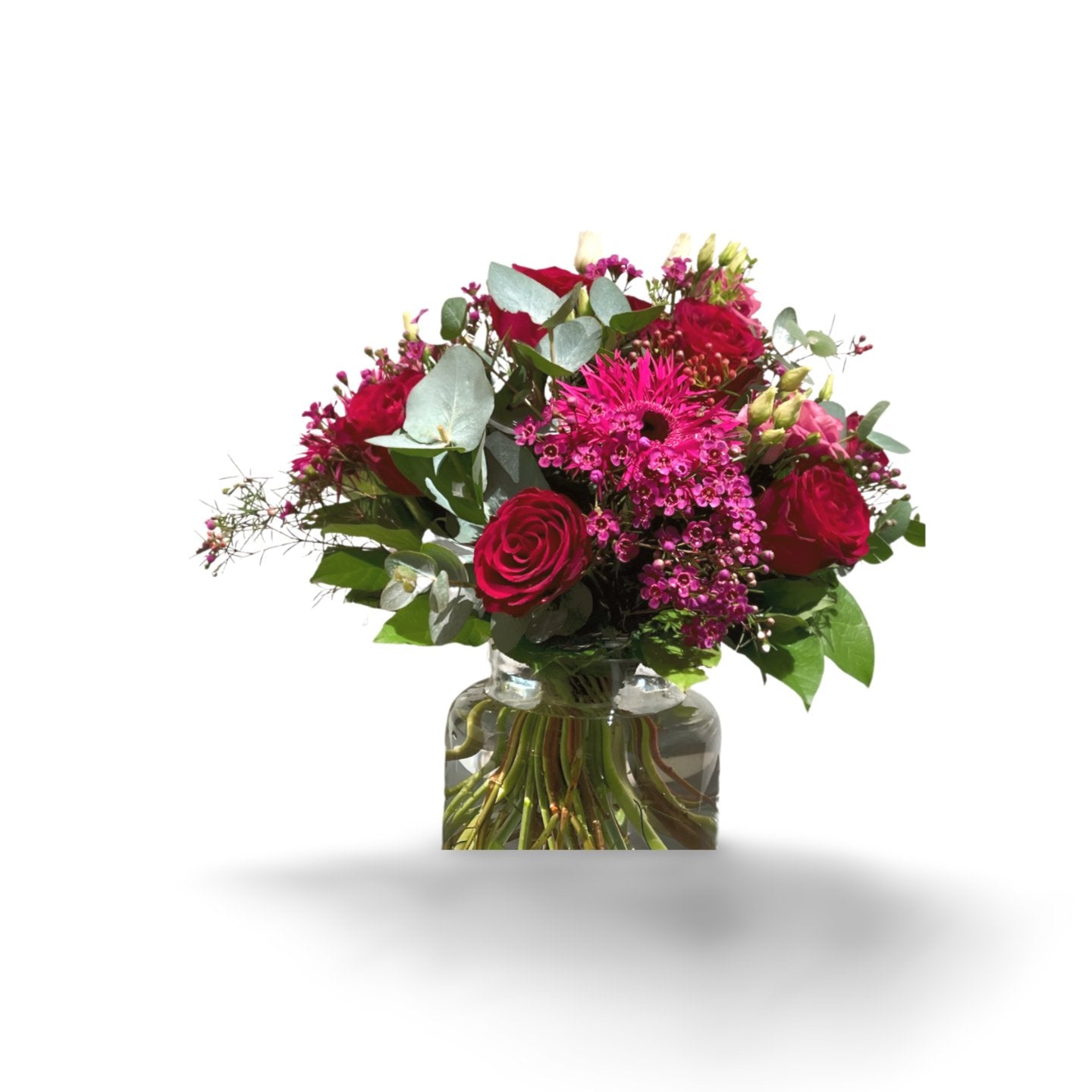 Die „Herzensangelegenheit“ Blumenstrauß von florali kombiniert rote und magentafarbene Rosen und Chrysanthemen mit grünen Blättern in einer Glasvase – ein farbenfroher Hingucker, der an Raspberry Ripple erinnert.